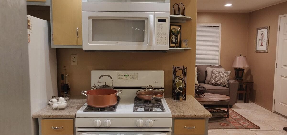Kitchen stove and counter opening toward the living area