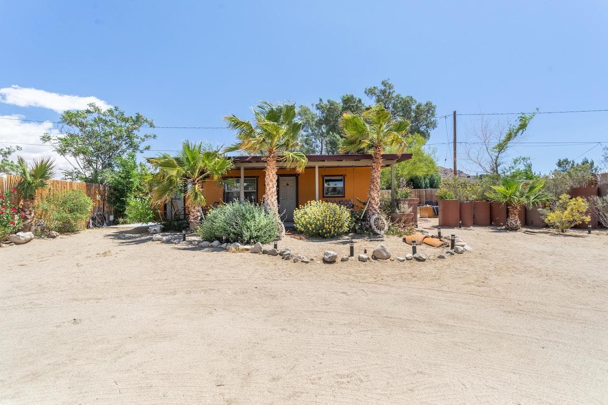 Wide view of Joshua Tree Bungalow and the desert yard
