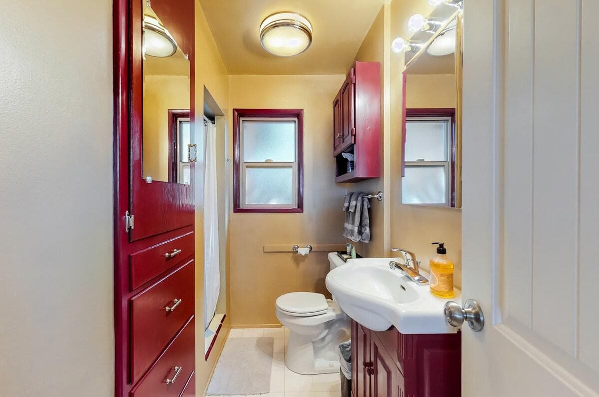 Colorful bathroom with shower sink and natural light