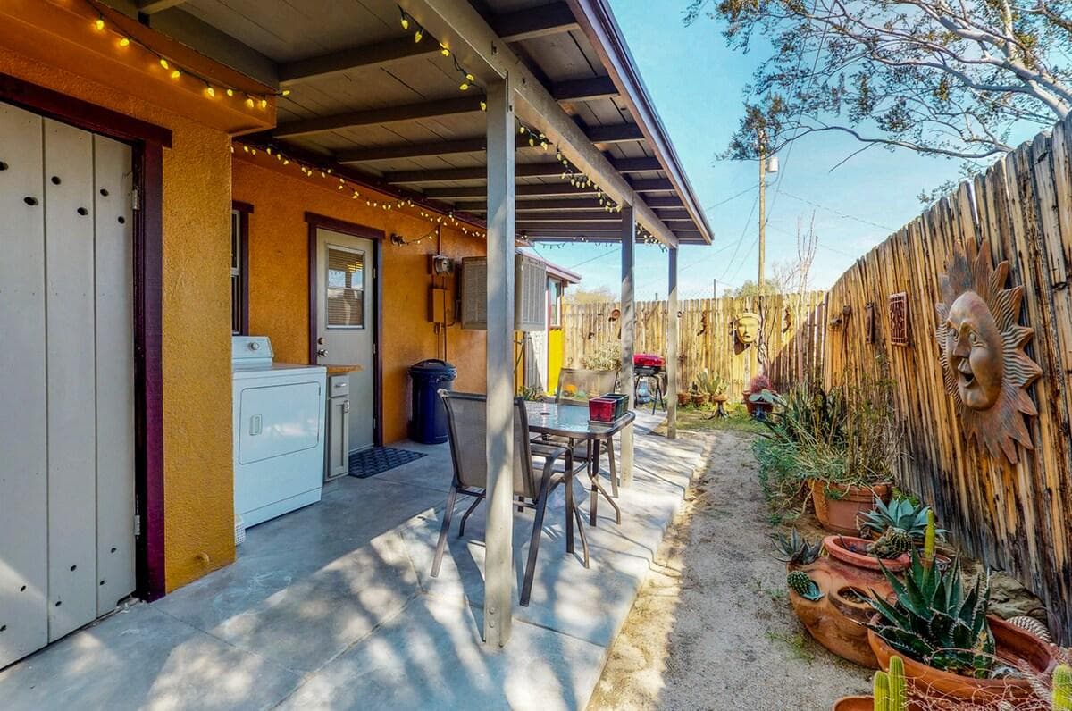Shaded side patio with outdoor table and desert plants